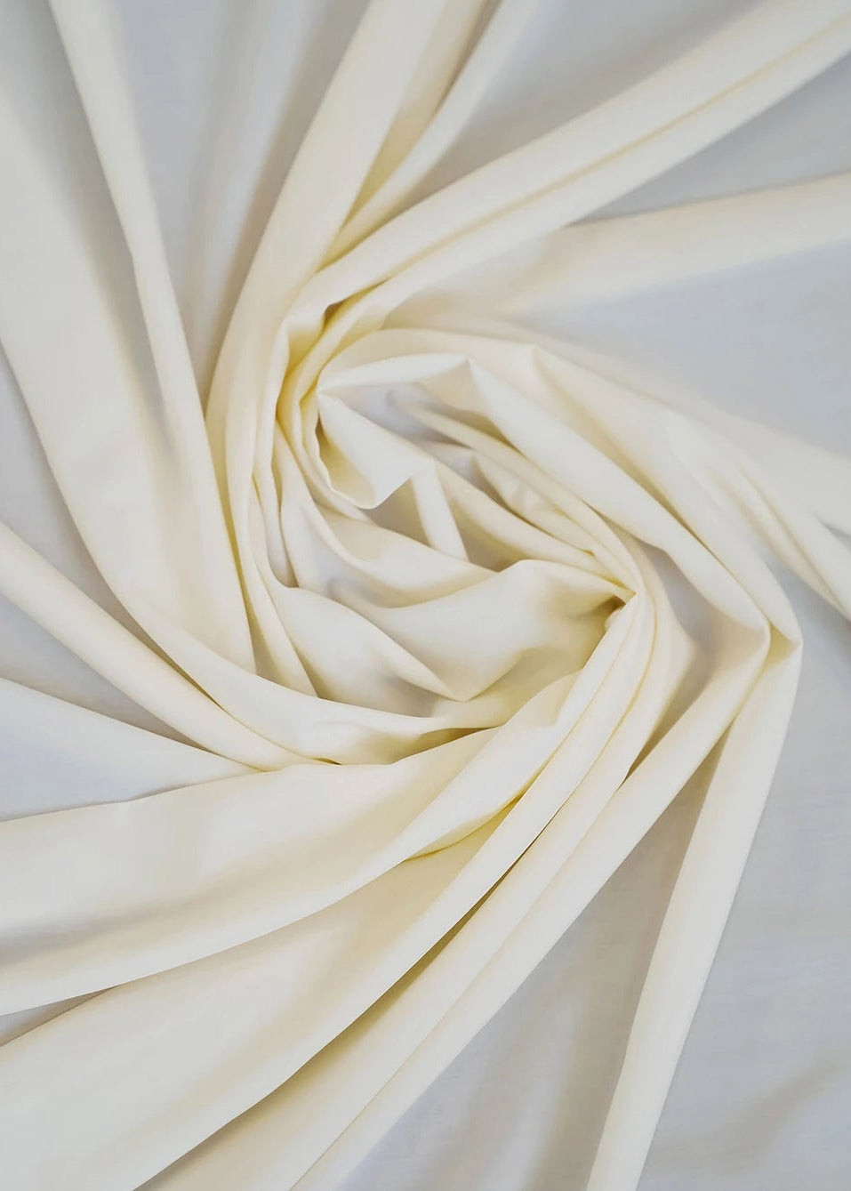 Oyster wash-and-wear fabric in light cream with visible folds and drape