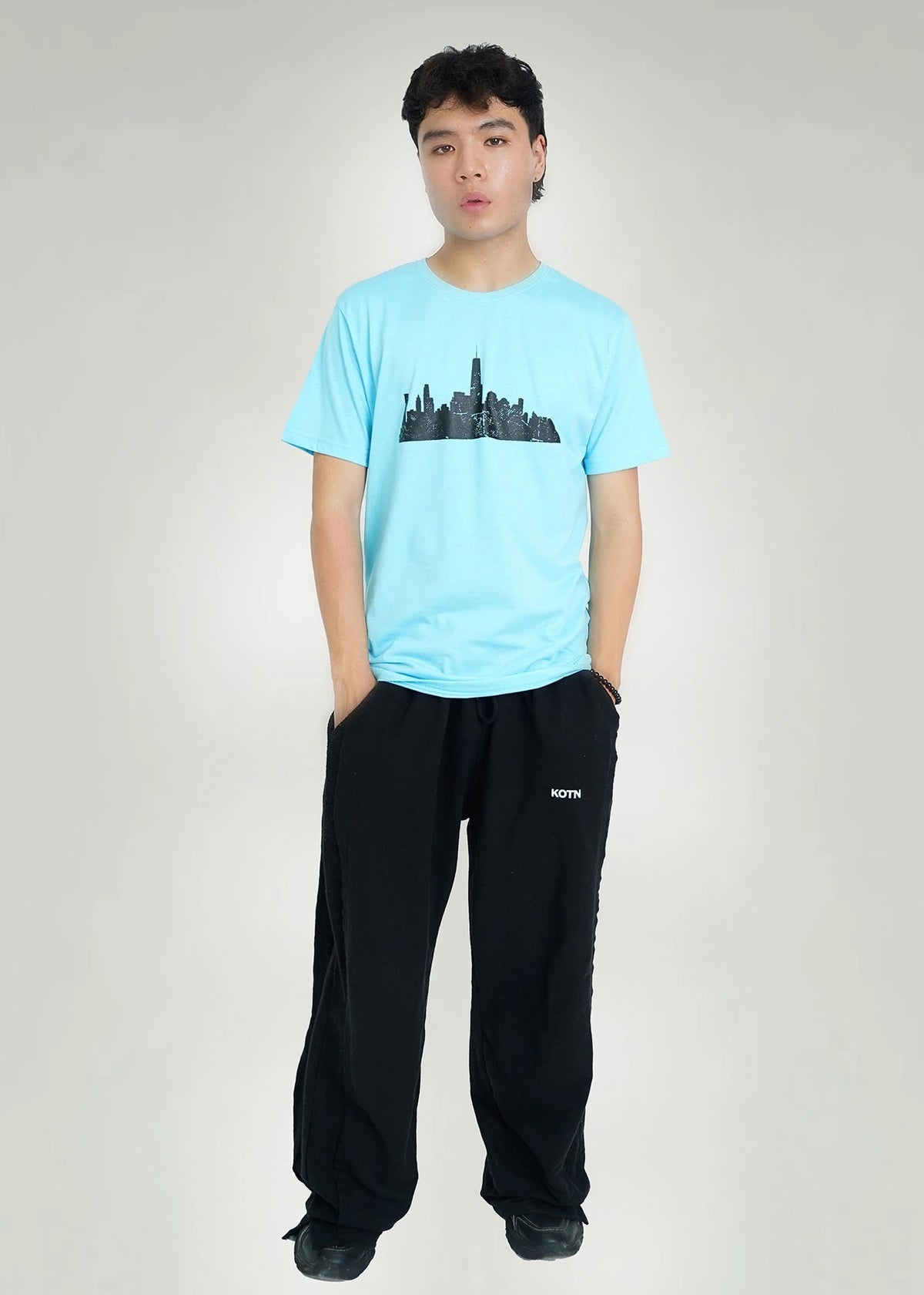 Men's sky-blue crew neck T-shirt with black city skyline graphic on chest