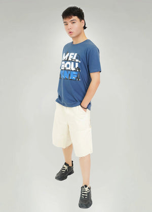 Men's navy round-neck T-shirt with city skyline graphic, worn with cream shorts