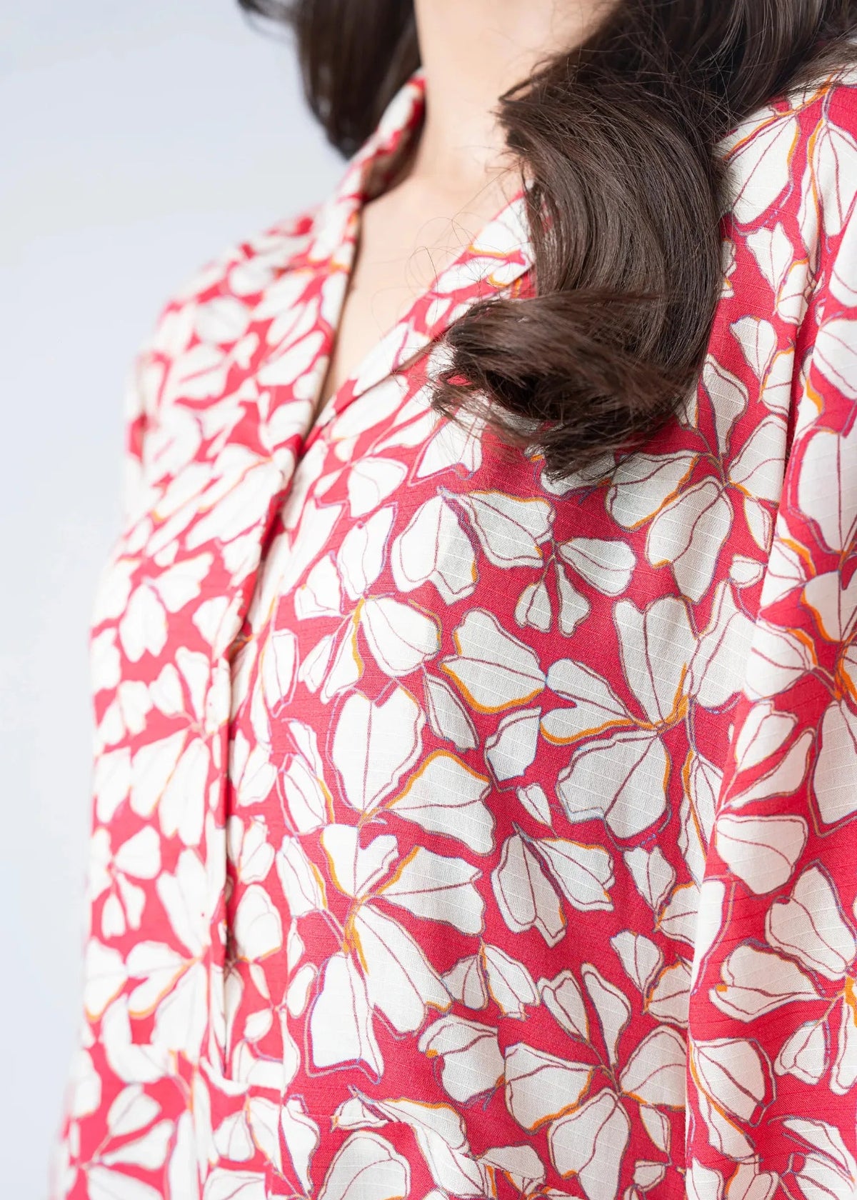 Pink and white abstract print long dress shoulder and neckline close-up