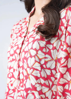 Pink and white abstract print long dress shoulder and neckline close-up