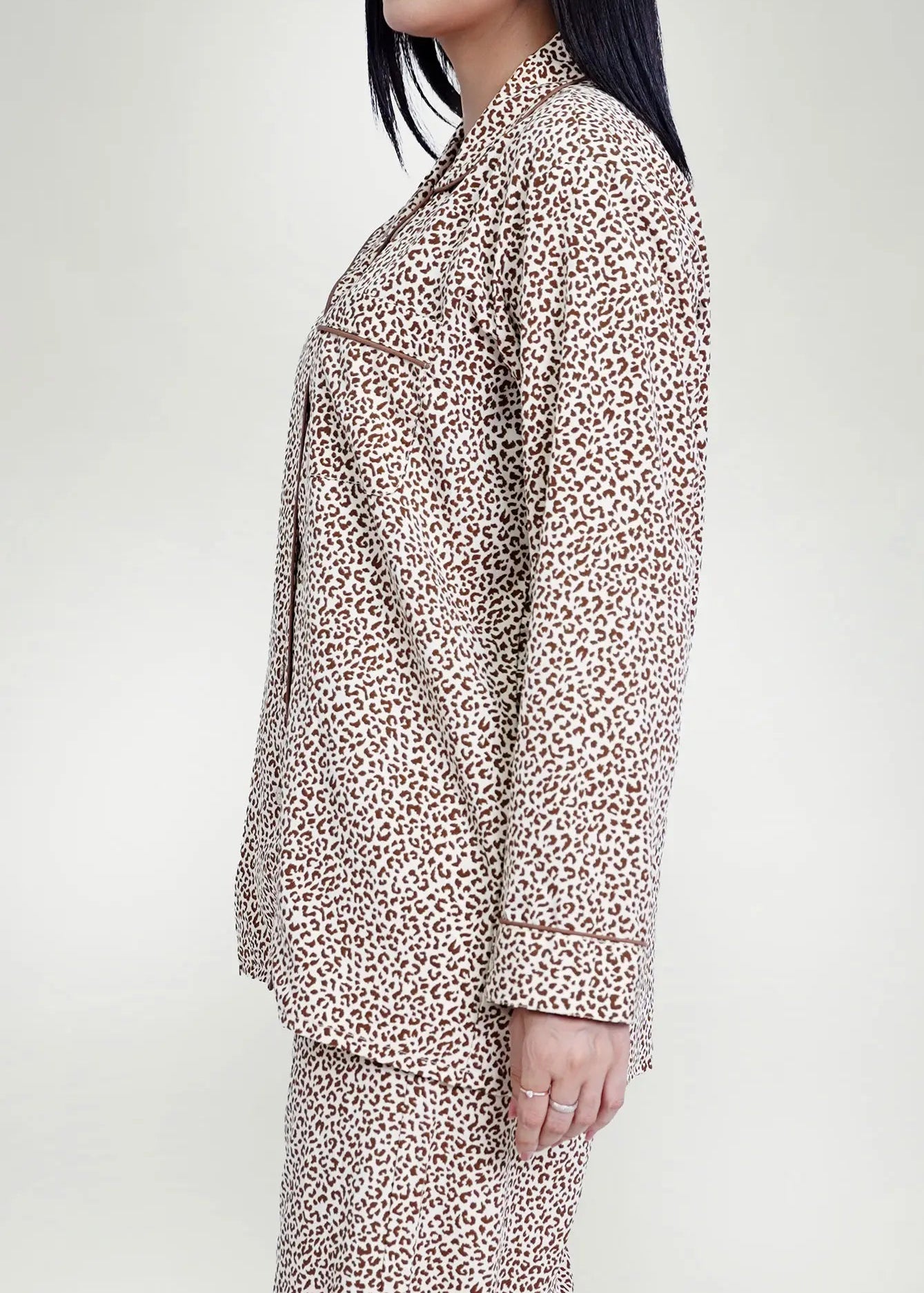 Men's silk night suit in light tan and brown leopard print, button-front top.